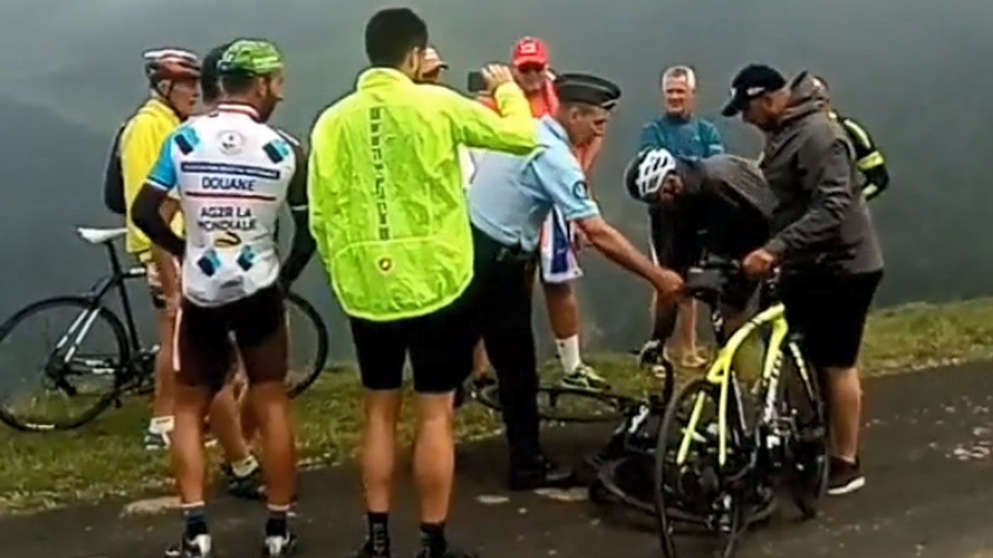 Police force Chris Froome off his bike during 17th stage of Tour de France