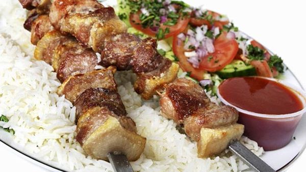 Pork skewers with rice and cucumber salad