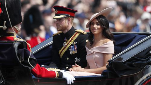 Britain's Prince Harry, left, and Meghan, Duchess of Sussex ride in a carriage to attend the annual Trooping the Colour Ceremony in London, Saturday, June 9, 2018.(AP Photo/Frank Augstein)