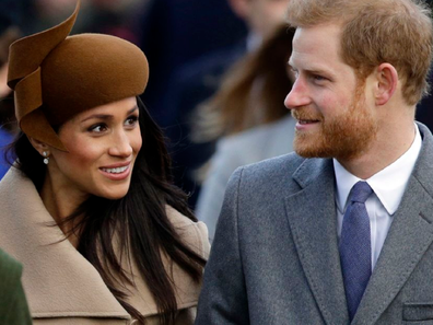 Meghan and Harry waling smiling