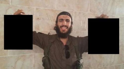 Mohamed Elomar holds up what is believed to be the severed heads of soldiers in Syria. (supplied)