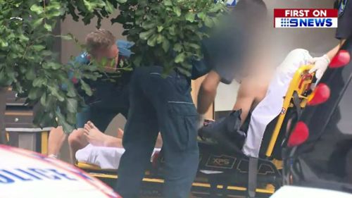 Paramedics assist the victim. (9NEWS)