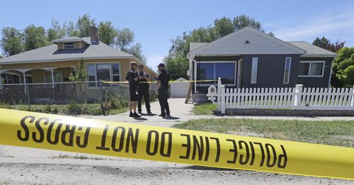 Police officers stand in front of the home, right, of Ayoola A. Ajayi  (AP Photo/Rick Bowmer)