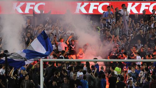 Fans light a flare during the round seven A-League match between the Melbourne Victory and Brisbane Roar at Etihad Stadium. (Getty)