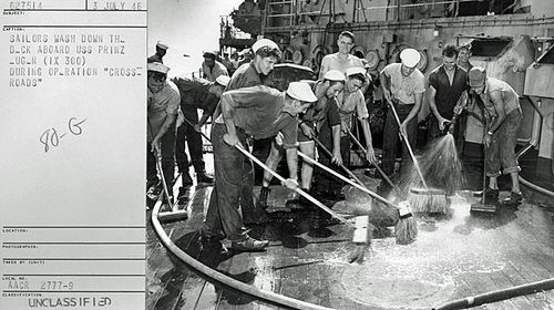 Sailors wash down the highly contaminated deck of the captured German battleship USS Prinz Eugene (IX 300) after the Baker explosion. The ship was so radioactive that it was later sunk. (National Security Archive)