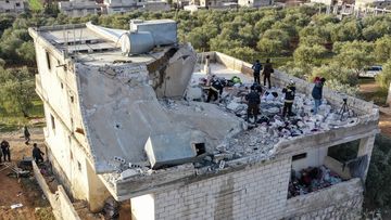People inspect a destroyed house following an operation by the U.S. military in the Syrian village of Atmeh, in Idlib province, Syria, Thursday, Feb. 3, 2022. 