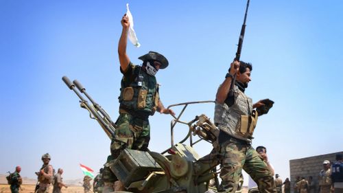 Iraqi troops celebrate after pushing ISIS fighters back. (Getty Images)