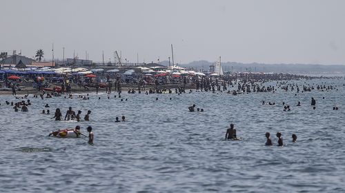 People enjoy a day at the beach, in Ostia, in the outskirts of Rome.  (Cecilia Fabiano/LaPresse via AP)