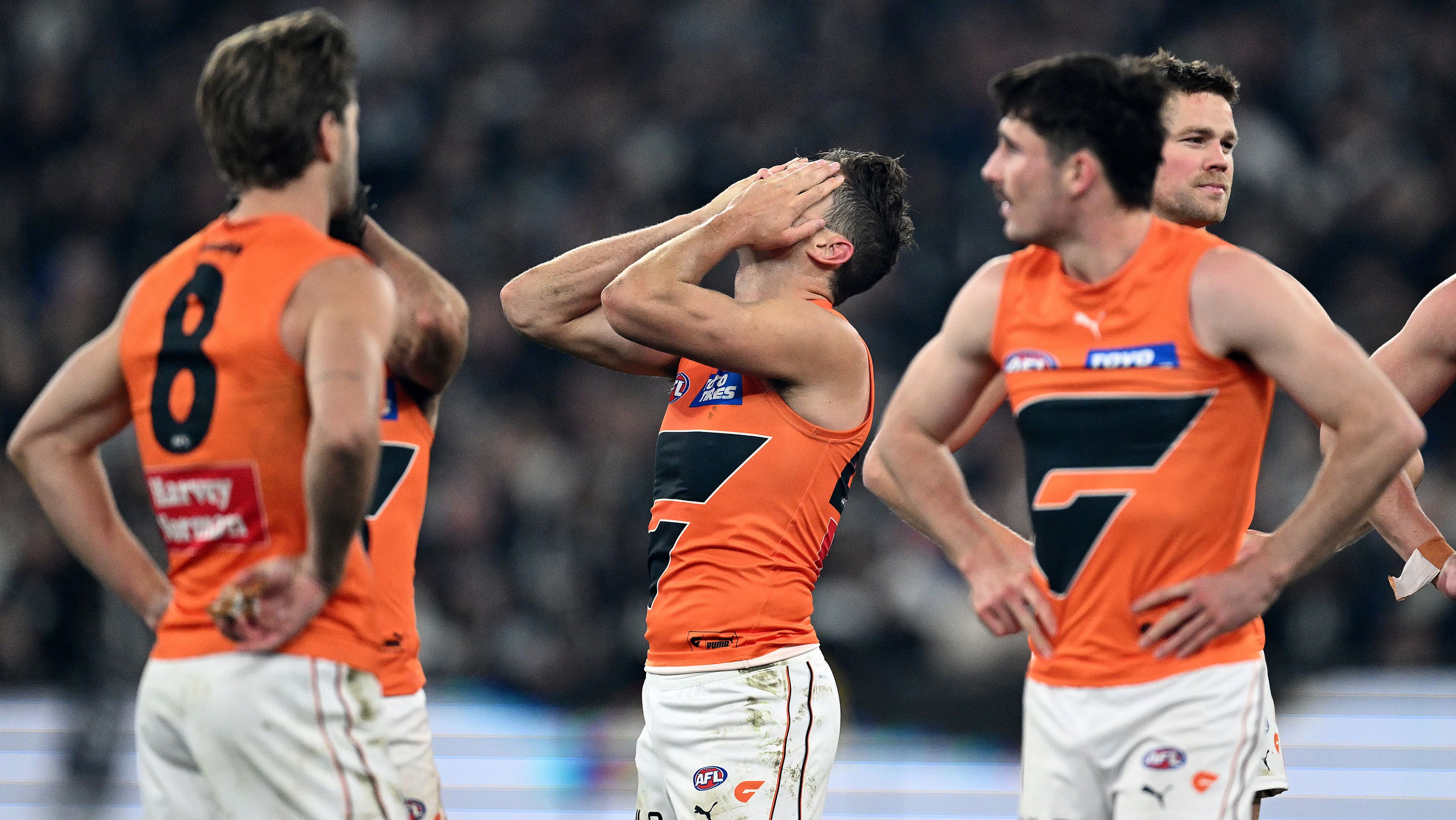 The Giants look dejected after losing their preliminary final loss to the Magpies.
