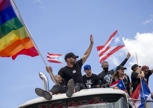 Ricky Martin, flying a gay pride flag, joins a protest to demand de resignation of Governor Ricardo Rossello from office, in San Juan, Puerto Rico.
