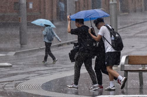 Heavy rain from storms sweep into the CBD with many caught out. Haymarket  Pic Nick Moir 19 Feb 2025