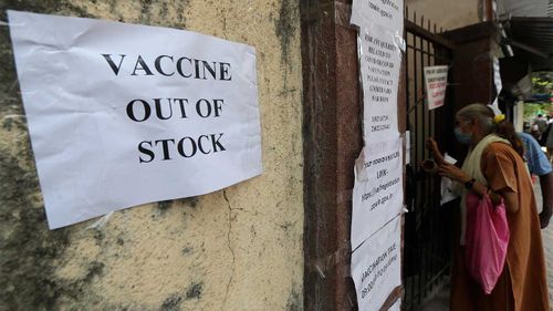 A note informing about the COVID-19 vaccine is seen pasted on a wall of a vaccination centre in Mumbai, India.