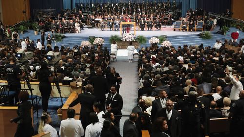 Aretha Franklin has been given one final farewell in a star-studded funeral procession, with her body covered in shimmering fabric in a closed golden casket.