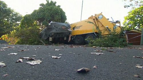 The garbage truck hit a caravan, boat and a car before smashing into the house. (9NEWS)