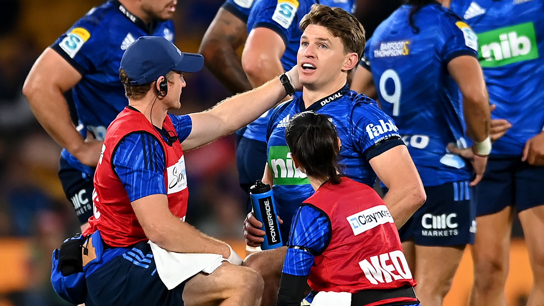 Beauden Barrett of the Blues receives attention from trainers during the round 13 Super Rugby Pacific match.