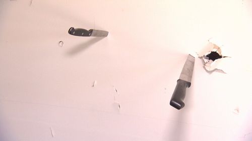Knives were stabbed into one wall of the Queensland home.