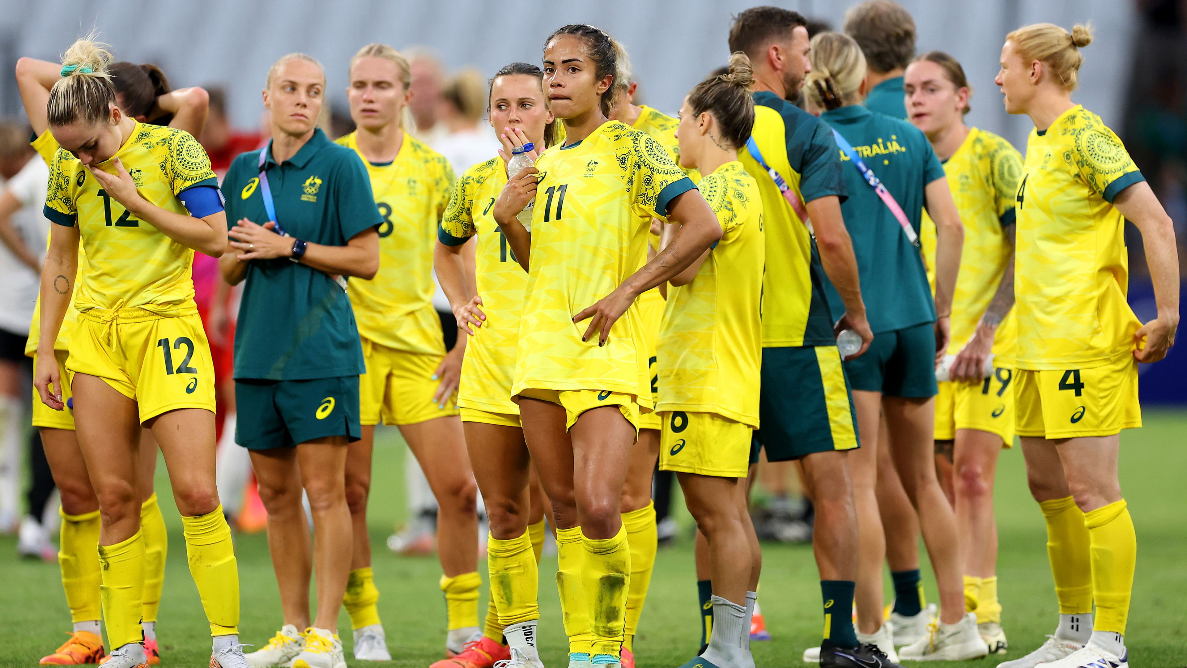 Players from Team Australia (Matildas) show dejection after losing to Germany.