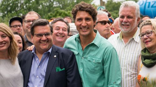 PM Trudeau smiles with Montreal's mayor. (AFP)