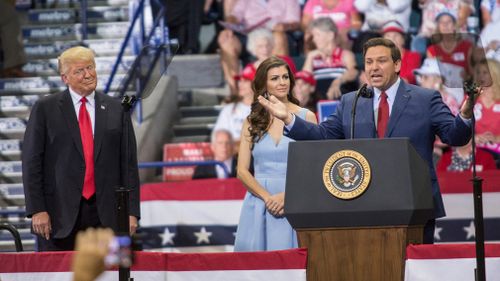 Florida Republican gubernatorial candidate Ron DeSantis speaks to supporters next to his wife Casey and the US President Donald J. Trump.
