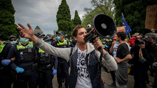 A protester speaks with a megaphone on October 23, 2020 in Melbourne, Australia