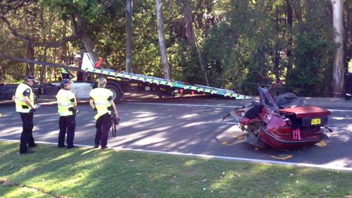 Woman critical after car hits power pole and splits in two on Ferry Road, Southport on the Gold Coast