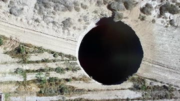 The sinkhole opened up in Chile on land owned by a Canadian mining company. 