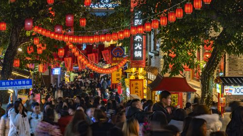 People tour the popular Shibati shopping street decorated with red lanterns 