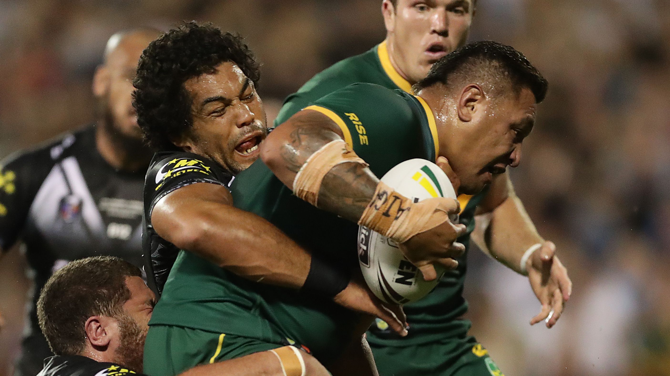 Josh Papalii of Australia is tackled at WIN Stadium.