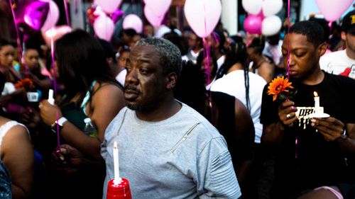 Tears are shed at a vigil in Dayton, Ohio.