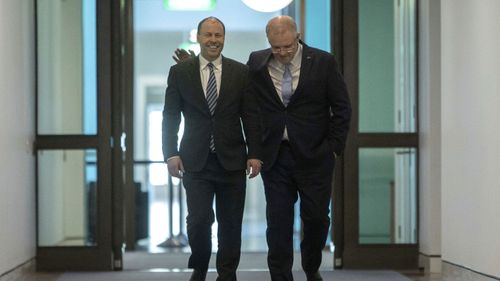 Mr Morrison walks with Mr Frydenberg through Parliament House.