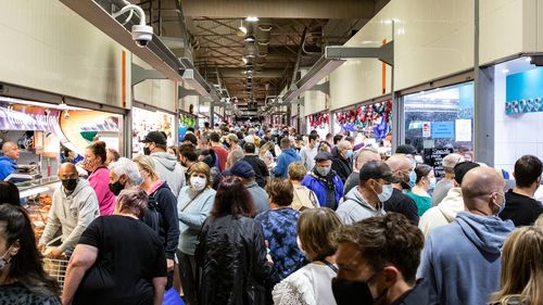 Crowds at Queen Victoria Market on Christmas Eve as Victoria reintroduced rules for masks to be worn indoors.