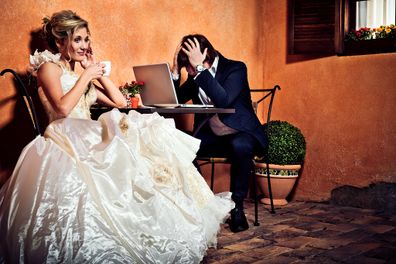 Bride and groom drinking coffee and using laptop