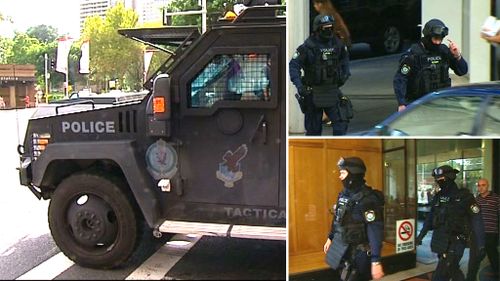Heavily armed police surrounded the complex. (9NEWS)