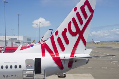 "Sydney, NSW, Australia - December 12, 2012: Virgin Australia plane with stairs waiting for passengers to board at Sydney Airport"