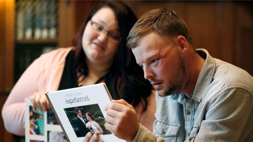 Lilly Ross, left, shows her family photos to Andy Sandness during their meeting at the Mayo Clinic. (AAP)