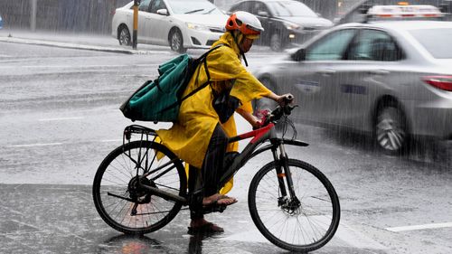 A cyclist battles the rain in Sydney.