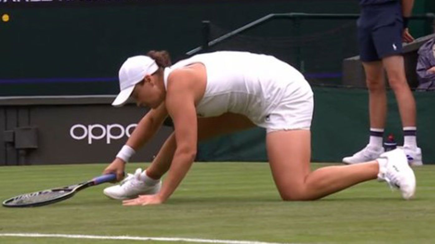 Ash Barty slips on her injured hip during her round one match at Wimbledon.