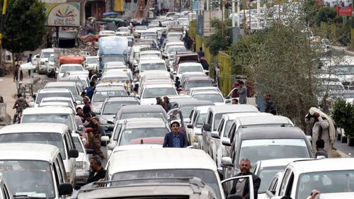 Yemeni drivers wait near their vehicles to reach a petrol station amid an acute shortage of fuel in Sana'a, Yemen.