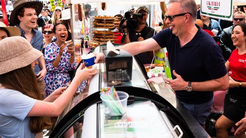 Prime Minister, Anthony Albanese, serves ice cream from Bar Italia, at the Norton Street Italian Festa in Sydney.