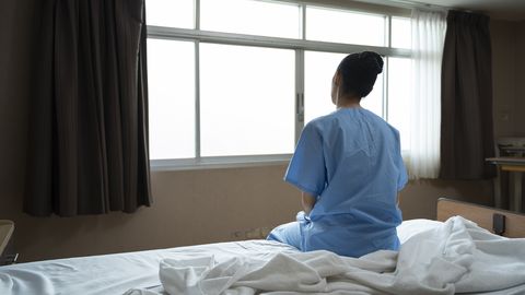 Long term patient with special treatment care plan is lonely sitting with depression while looking out the window for hopeful recovery progress and ptsd