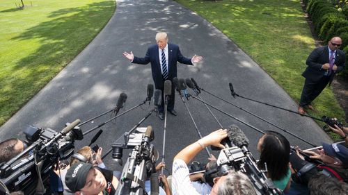 Donald Trump speaks to reporters outside the White House.