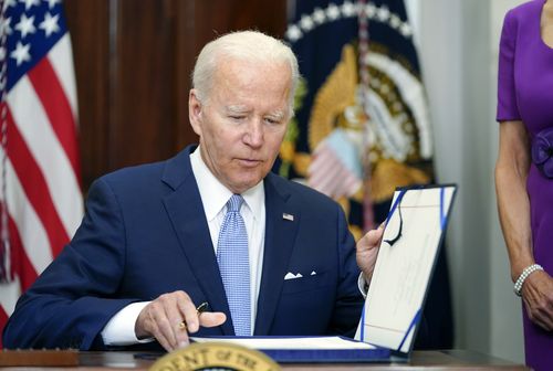 President Joe Biden signs into law S. 2938, the Bipartisan Safer Communities Act gun safety bill, in the Roosevelt Room of the White House in Washington, Saturday, June 25, 2022