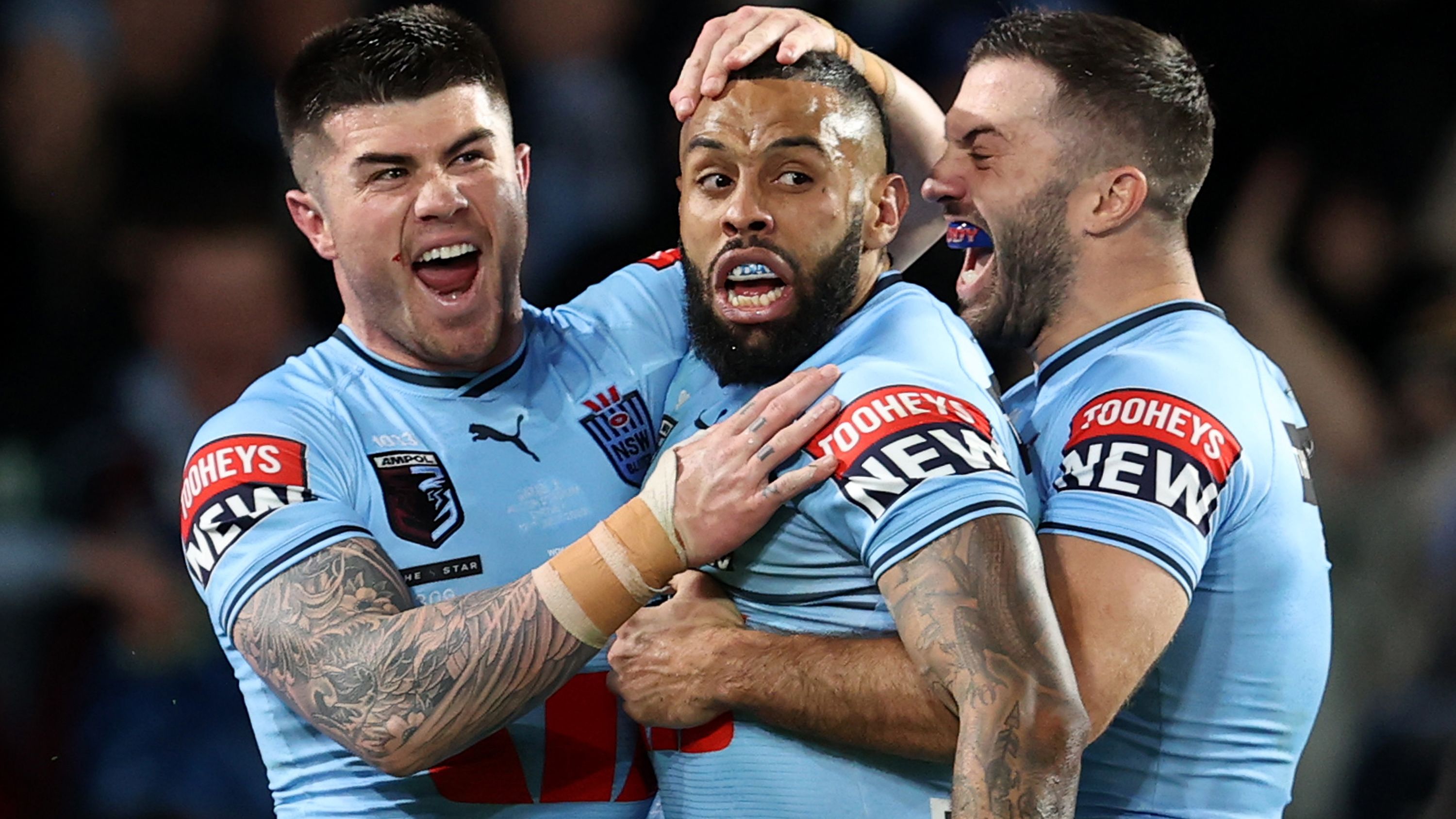 Josh Addo-Carr of the Blues celebrates scoring a try with Bradman Best and James Tedesco during game three of the State of Origin series.