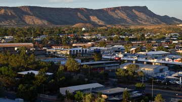 Alice Springs man hospitalised after running into police car