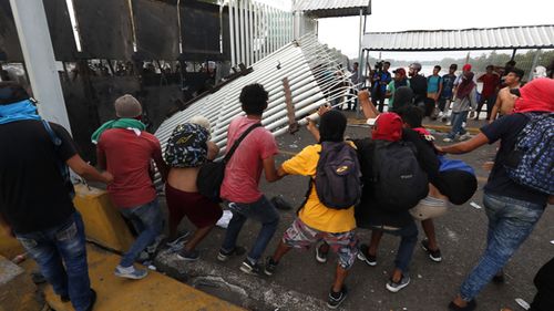 Central American migrants of the second caravan confront the police in Tecun Uman, Guatemala. Thousands of migrants broke through the border fence between Guatemala and Mexico and crossed to Mexican territory.