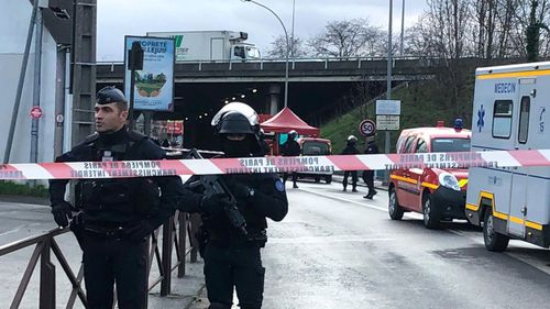 Police officers secure the area after a man attacked passerby Friday Jan.3, 2020 in Villejuif, south of Paris. A man armed with a knife attacked passers-by Friday in a southern Paris park, injuring some, before being shot by police, French officials said.