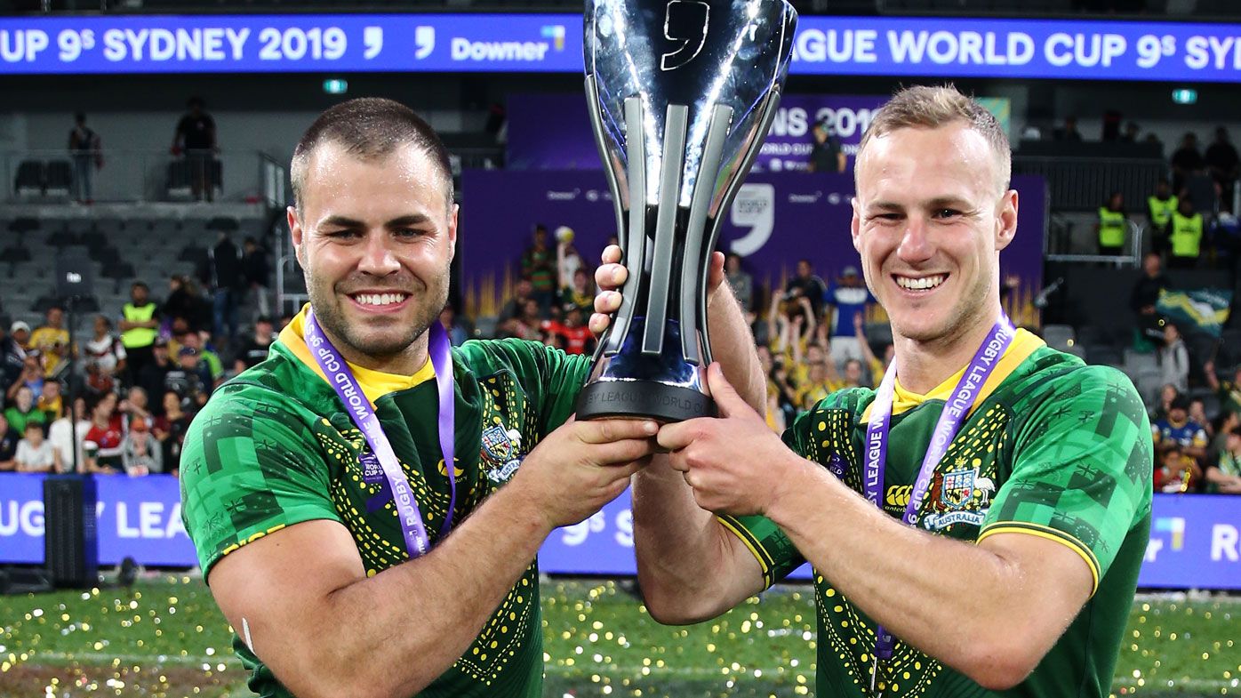 Wade Graham and Daly Cherry-Evans of Australia celebrate with the trophy after victory