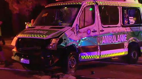 It’s believed the white hatchback t-boned the ambulance which caused it to flip onto its side. (9News)