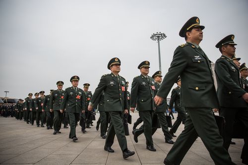 Chinese military delegates arrive for the third plenary session of the 13th National People's Congress in Beijing last month. (AAP)