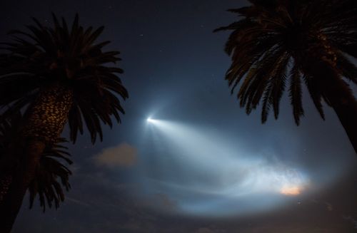 A SpaceX Falcon 9 rocket lights up the sky after its launch from Vandenberg Air Force base as seen in the sky over Corona del Mar, California